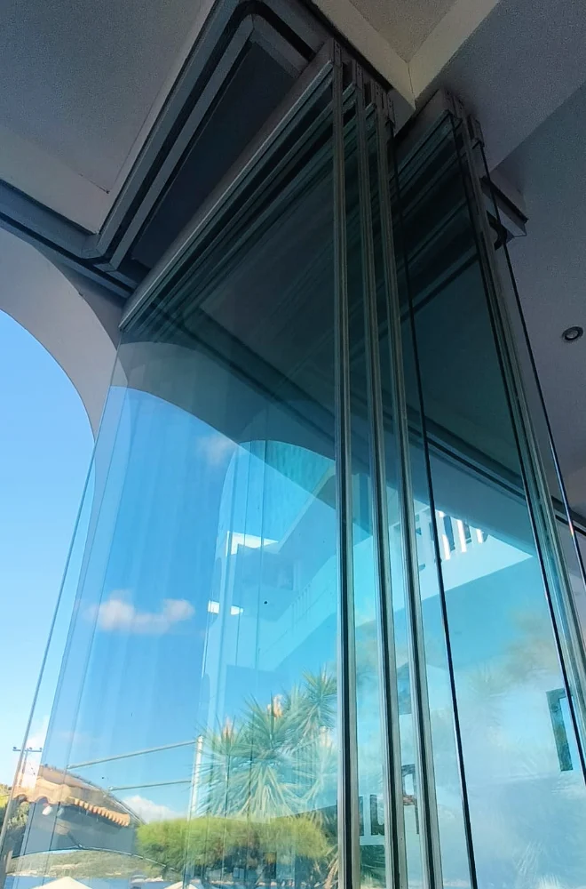 Folding glass panels and the top track, seen from below