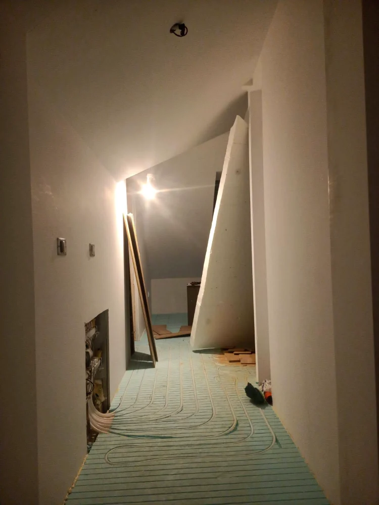Engineered wood flooring laid in a herringbone pattern, in the last stage of installation