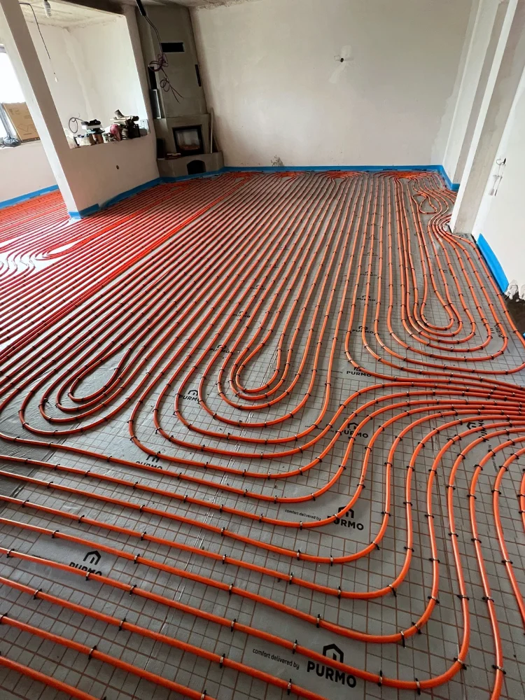Underfloor heating pipes laid in a spiral on insulation boards