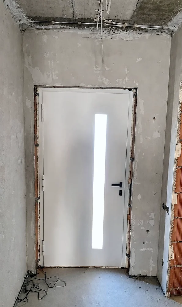White entrance door with a narrow glass insert