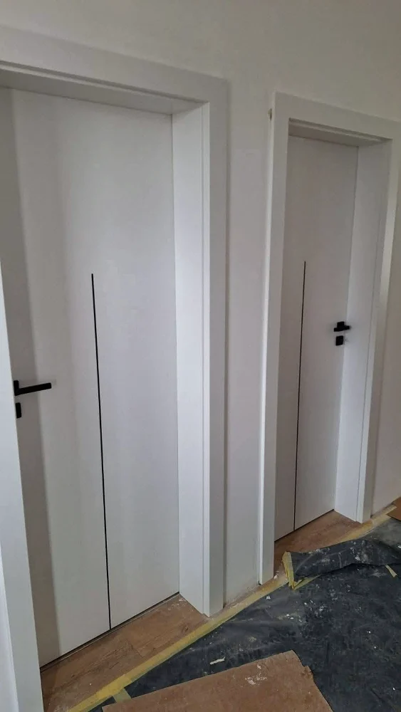 Minimalist white interior doors with black handles