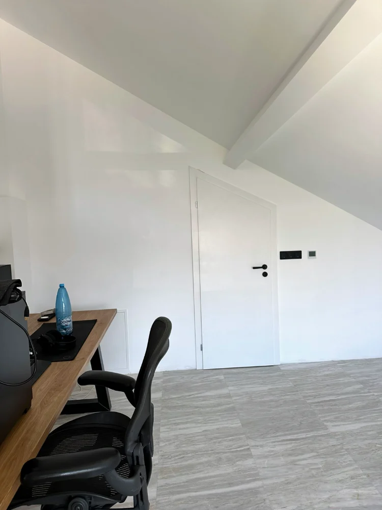White door in a non-standard size, under a slope