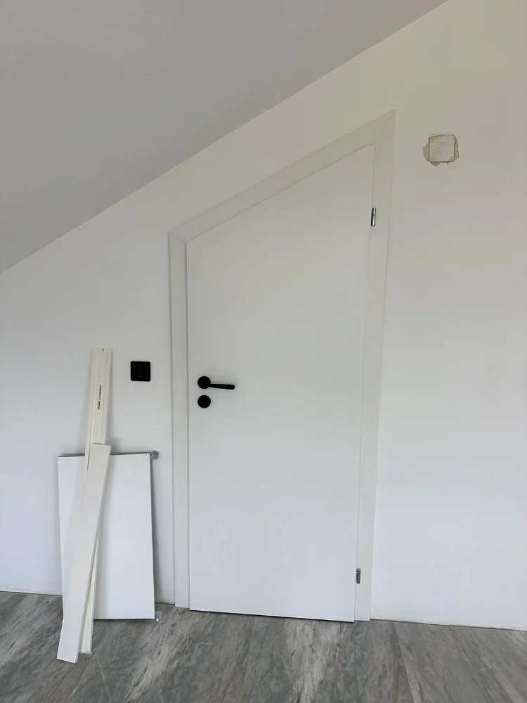 Non-standard white door under a slope, with a cut-out frame
