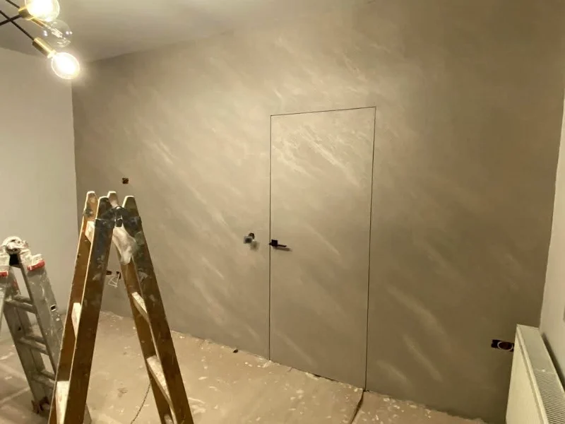 Filomuro door in a wall with a decorative finish
