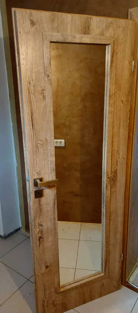 Wood-effect door with a mirror for a dressing room