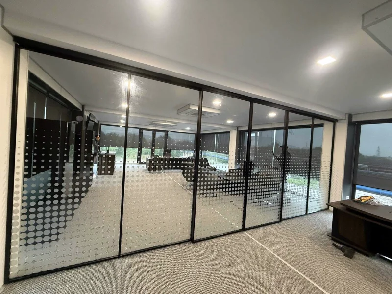 Glass walls and doors with black profiles, in an office space