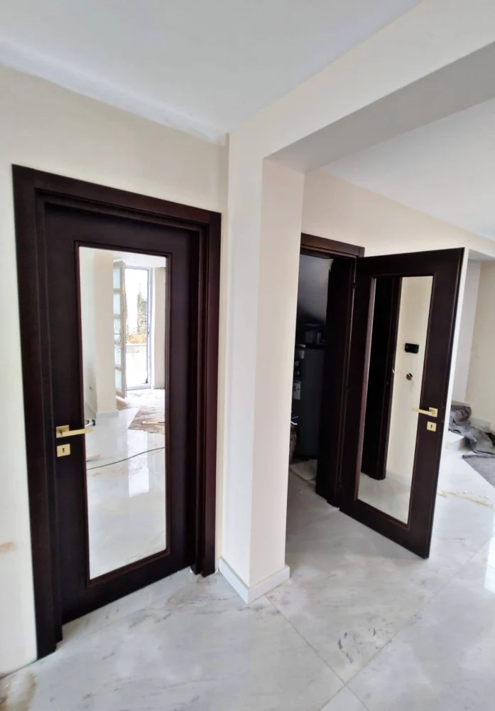 Dark interior doors with a glass panel, during installation